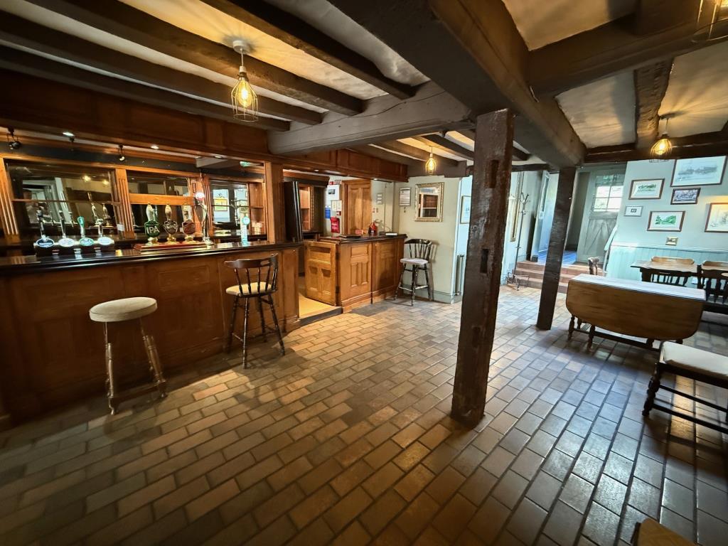 Lot: 129 - FREEHOLD PUBLIC HOUSE SITUATED IN POPULAR SUFFOLK VILLAGE LOCATION - main bar area with fireplace and access to WC's